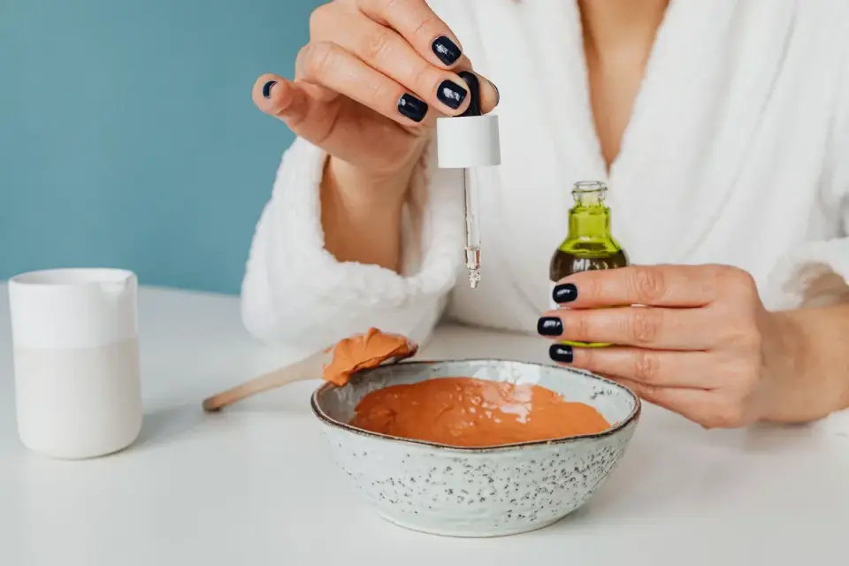A dropper bottle of calming supplement beside a dog's food bowl