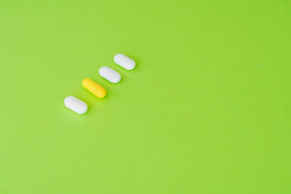 Whole-food chews next to isolated-nutrient capsules on a kitchen counter